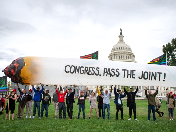 Marijuana activists hold up an inflatable joint during a rally at the U.S. Capitol